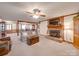 Inviting living room featuring a brick fireplace, wooden beams, and access to the dining area at 2615 High Ridge Church Rd, Marshville, NC 28103