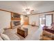 Inviting living room featuring a brick fireplace, wooden beams, and access to the outdoor porch at 2615 High Ridge Church Rd, Marshville, NC 28103