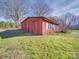 Rustic red metal outbuilding with boarded up windows and an overgrown yard at 2615 High Ridge Church Rd, Marshville, NC 28103