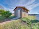 Outbuilding with wood siding, small concrete path leading to door, and blue propane tank in the yard at 2615 High Ridge Church Rd, Marshville, NC 28103