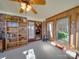 Bright sunroom with brick accent wall, shelving, and access to the backyard through sliding glass doors at 2615 High Ridge Church Rd, Marshville, NC 28103