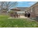 Patio with grill, and dining furniture beneath string lights in backyard at 304 W Park Ave, Charlotte, NC 28203