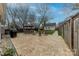 Paver patio with dining table, chairs, grill and firepit in fenced backyard at 304 W Park Ave, Charlotte, NC 28203