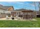 A backyard patio area with a table, chairs, fire pit and an open green space at 304 W Park Ave, Charlotte, NC 28203