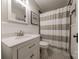 Clean bathroom with a single vanity, wainscoting, and black and white tile at 304 W Park Ave, Charlotte, NC 28203