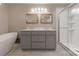 Bright bathroom featuring a double vanity, modern tub, and a separate glass-enclosed shower at 304 W Park Ave, Charlotte, NC 28203