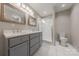Well-lit bathroom featuring a double vanity, glass enclosed shower, and modern toilet at 304 W Park Ave, Charlotte, NC 28203