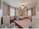 Bright bedroom featuring a twin bed, ceiling fan, area rug, and two large windows at 304 W Park Ave, Charlotte, NC 28203