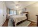 Comfortable bedroom with a large bed, ceiling fan, a sitting chair by the bright window at 304 W Park Ave, Charlotte, NC 28203