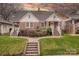 Charming brick home with a landscaped front yard and inviting front porch with white railings at 304 W Park Ave, Charlotte, NC 28203
