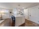 Well-lit kitchen with center island, white cabinets, and access to additional living space at 304 W Park Ave, Charlotte, NC 28203