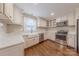 Well-lit kitchen features white cabinets, stainless appliances, and hardwood floors at 304 W Park Ave, Charlotte, NC 28203