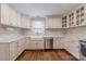 Updated kitchen boasts white cabinetry, stainless steel appliances, and a farmhouse sink at 304 W Park Ave, Charlotte, NC 28203