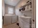 Functional laundry room with sink, cabinets, window, and washer and dryer at 304 W Park Ave, Charlotte, NC 28203