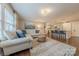 Open-concept living room, with kitchen, featuring hardwood floors and fireplace at 304 W Park Ave, Charlotte, NC 28203