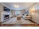 Bright living room featuring fireplace, neutral walls, hardwood floors, and ample light at 304 W Park Ave, Charlotte, NC 28203