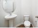 Bathroom features a pedestal sink, oval mirror and modern fixtures at 3164 Ora Smith Rd, Lincolnton, NC 28092