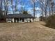 Cozy tan home with green shutters, complemented by a large front lawn and a storage shed in the back at 321 Creek Se Trl, Concord, NC 28025