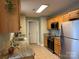 Functional kitchen with granite countertops, oak cabinets, and stainless-steel appliances at 321 Creek Se Trl, Concord, NC 28025