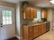 Bright kitchen with granite countertops, oak cabinets, and view to the backyard at 321 Creek Se Trl, Concord, NC 28025
