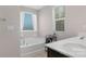 Bright bathroom features a soaking tub next to a window and a double vanity with plenty of counter space at 3230 Yarmouth Ln, Gastonia, NC 28056