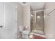 Bathroom features tiled shower with glass doors, a toilet, and a crisp white door at 3230 Yarmouth Ln, Gastonia, NC 28056