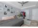 Bright bedroom with neutral walls, ceiling fan, and a full-size bed with plush pillows at 3230 Yarmouth Ln, Gastonia, NC 28056