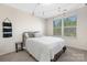Full-size bed with neutral carpet and a window for natural light and a dark metal bedframe at 3230 Yarmouth Ln, Gastonia, NC 28056