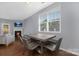 Well-lit dining area with hardwood floors, an inviting wooden table, and views of the fireplace at 3230 Yarmouth Ln, Gastonia, NC 28056