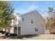 A three-story home with light siding features an attached garage and partially-covered front porch at 3230 Yarmouth Ln, Gastonia, NC 28056