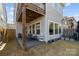 This backyard features an outdoor dining area, a covered patio and well manicured landscaping at 343 Belton St, Charlotte, NC 28209