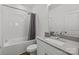 Bathroom featuring shower-tub combo, subway tile, and a light gray vanity at 343 Belton St, Charlotte, NC 28209