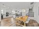 Open concept dining room and kitchen area with hardwood floors, modern lighting and stainless appliances at 343 Belton St, Charlotte, NC 28209
