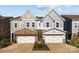 Charming townhome with neutral siding, stone accents, attached garages, and well-manicured landscaping at 343 Belton St, Charlotte, NC 28209
