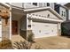 Inviting townhome featuring a stylish orange door, stone accents, and a well-maintained attached garage at 343 Belton St, Charlotte, NC 28209