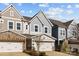 Attractive two-story townhome featuring a stone accented facade, a two-car garage and a manicured lawn at 343 Belton St, Charlotte, NC 28209