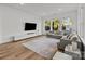 Spacious living room featuring hardwood floors, a large rug, comfortable seating and plenty of natural light at 343 Belton St, Charlotte, NC 28209