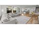 Open living space with hardwood floors, a large couch, and seamlessly connected to the kitchen and dining area at 343 Belton St, Charlotte, NC 28209