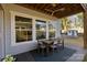 Relaxing outdoor patio with dining table, fan, and view of the backyard at 343 Belton St, Charlotte, NC 28209