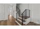 Modern staircase with black railings and hardwood steps leading to the upper level at 343 Belton St, Charlotte, NC 28209