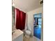 Classic bathroom with neutral tile and classic toilet beside an open doorway at 3437 Wilkesboro Hwy, Statesville, NC 28625