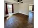 Hardwood-floored bedroom with natural lighting, a ceiling fan, and views outside the window at 3437 Wilkesboro Hwy, Statesville, NC 28625
