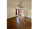 Bedroom featuring dark hardwood floors, a ceiling fan, natural light, and a bathroom doorway at 3437 Wilkesboro Hwy, Statesville, NC 28625