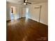 Bright bedroom with ceiling fan, hardwood flooring, A/C, and open doorway to the bathroom at 3437 Wilkesboro Hwy, Statesville, NC 28625