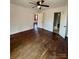 Bedroom with hardwood flooring, a ceiling fan, and doorway to bathroom and adjacent room at 3437 Wilkesboro Hwy, Statesville, NC 28625
