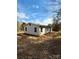 Single-story home with gray siding and natural landscaping, offering a serene and private setting at 3437 Wilkesboro Hwy, Statesville, NC 28625
