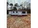 Charming single-story home featuring light gray siding, a red brick foundation and a well-manicured yard at 3437 Wilkesboro Hwy, Statesville, NC 28625