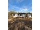 Rear exterior of a cozy, single-story home with gray siding and a tranquil natural backdrop at 3437 Wilkesboro Hwy, Statesville, NC 28625