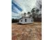 Single-story home featuring light gray vinyl siding, a dark roof, and a spacious front yard at 3437 Wilkesboro Hwy, Statesville, NC 28625