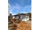 A single-story home with light gray vinyl siding, dark shingles, set in a natural outdoor setting at 3437 Wilkesboro Hwy, Statesville, NC 28625